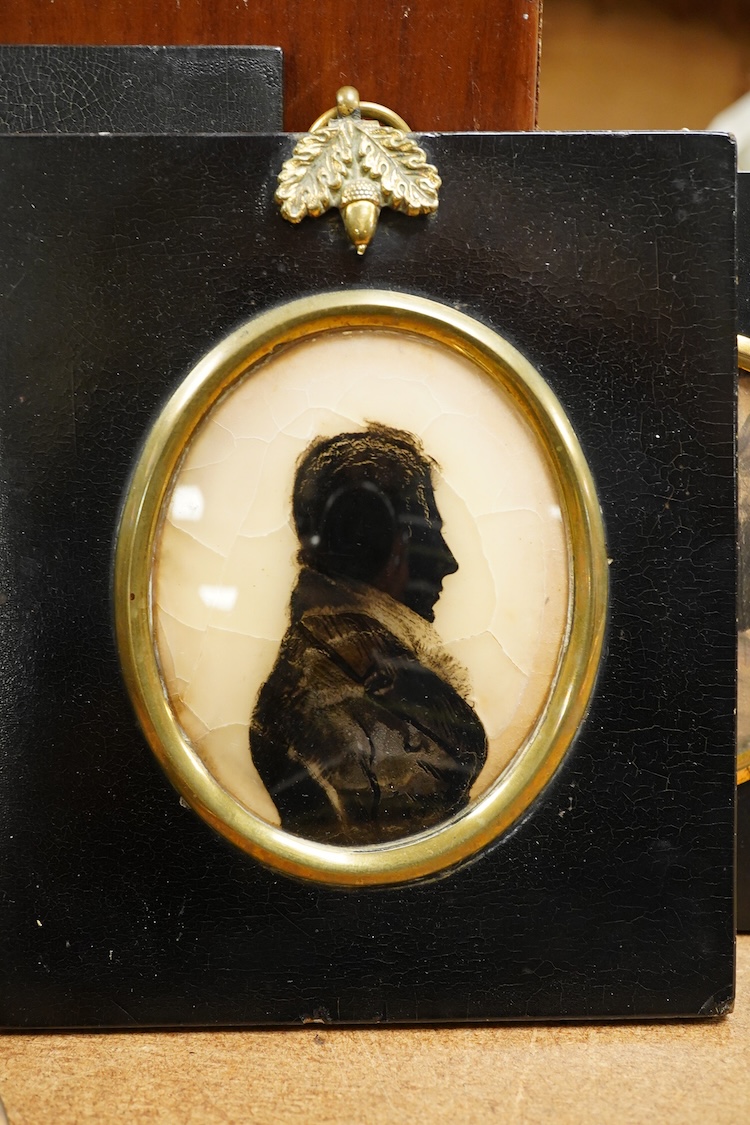 Two 19th century silhouette portraits to include one painted on glass by R. N. Barnes 1836 together with a portrait miniature of a Regency lady and an enamel example, largest 8 x 6.5cm (4)